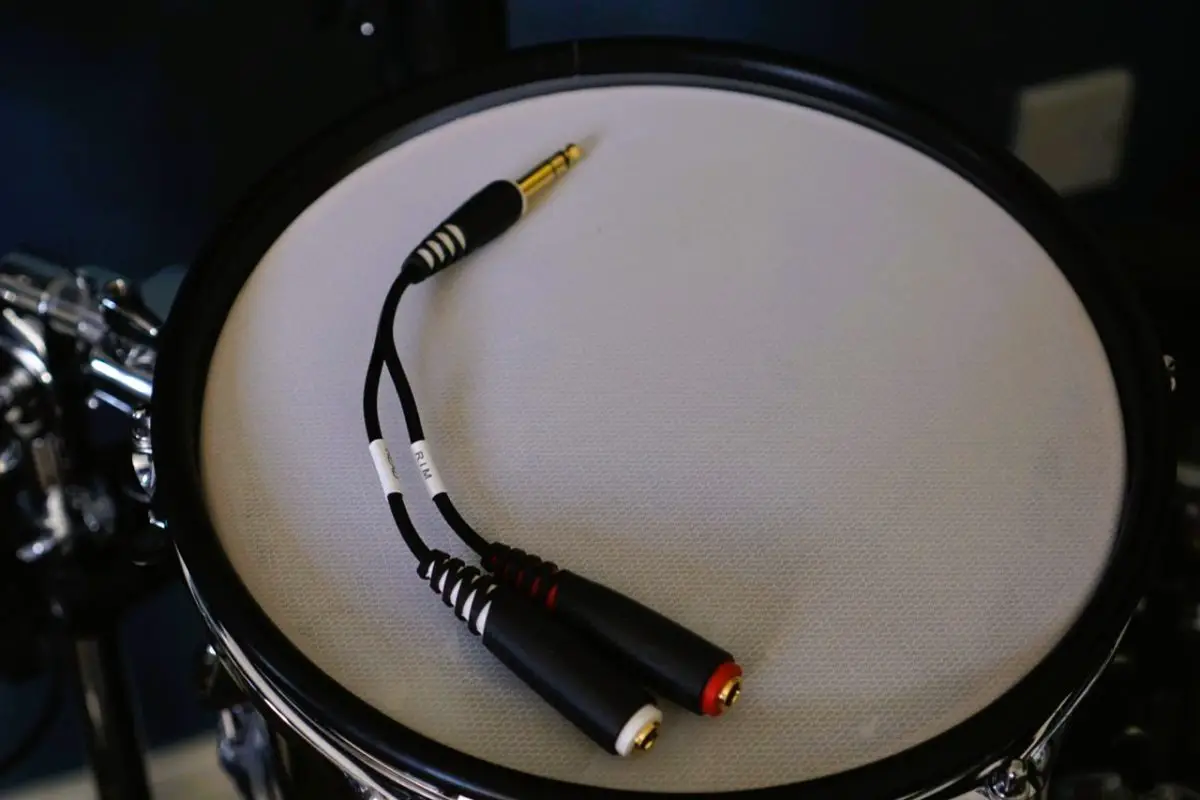 A drum-tec splitter cable resting on an electronic drum pad