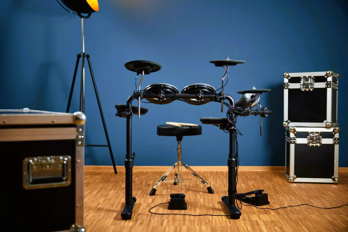 The Rookie by Millenium drums in a studio against a blue wall, showing the two foot pedals