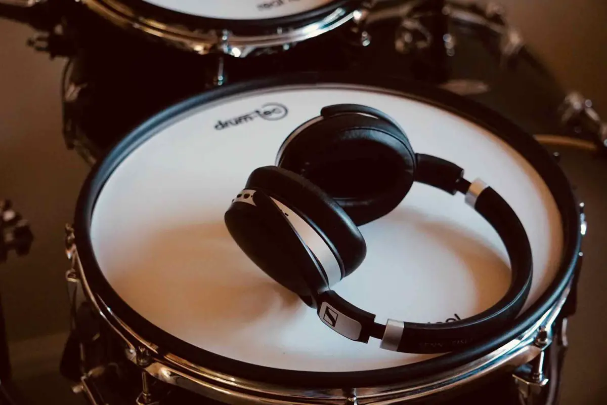 a pair of headphones resting on top of an electronic snare drum